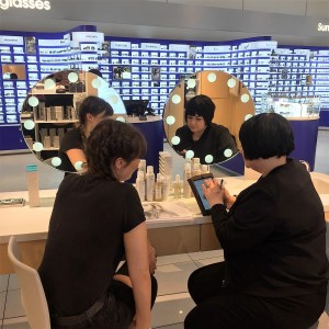 Nikki Taylor trains a Selfridges Birmingham team member on OUAI Haircare